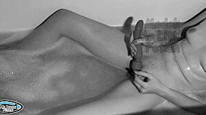 Slim woman enjoys evening bath with vibrator, reaching an orgasm